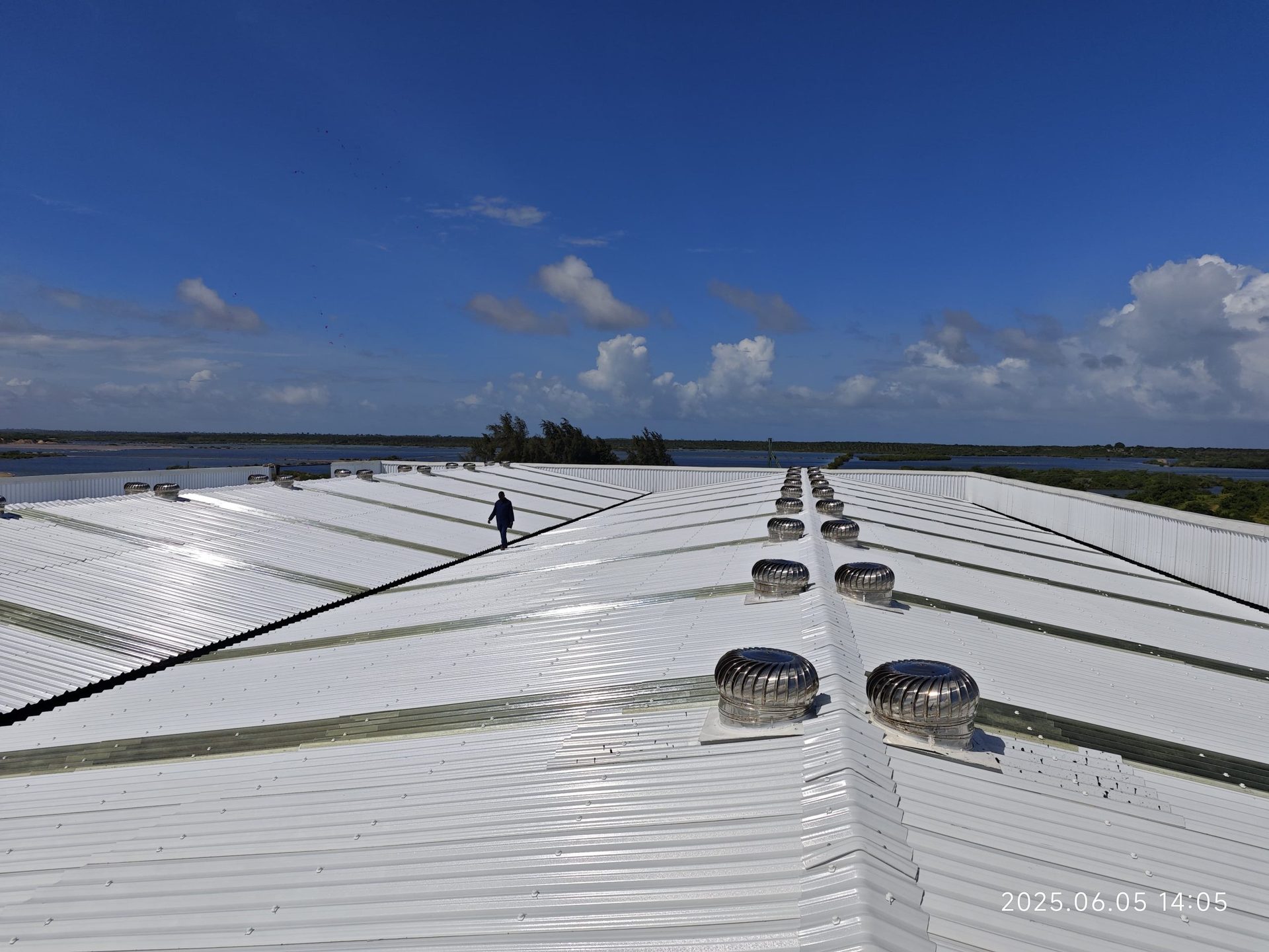 White Muwi S-ACT sheets with cyclone fans on an industrial roof