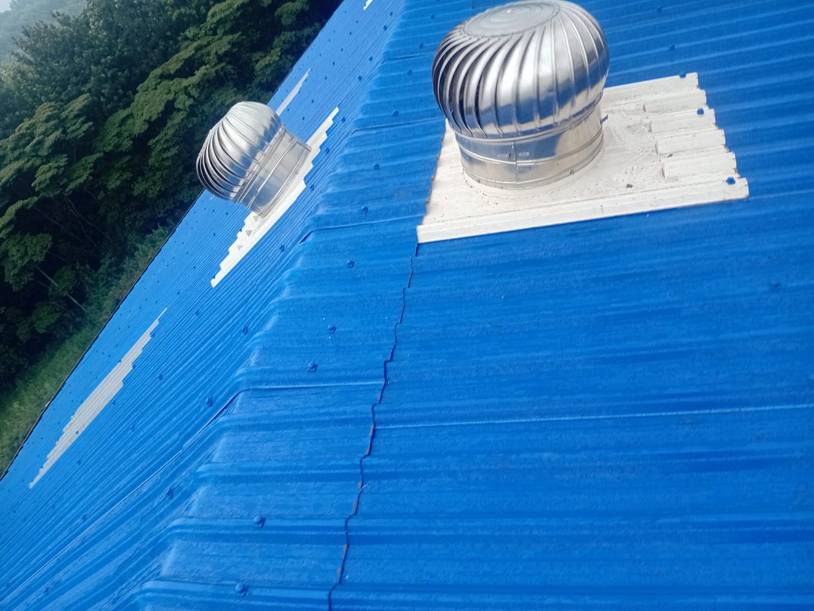 Muwi cyclone fans on a blue S-ACT roof
